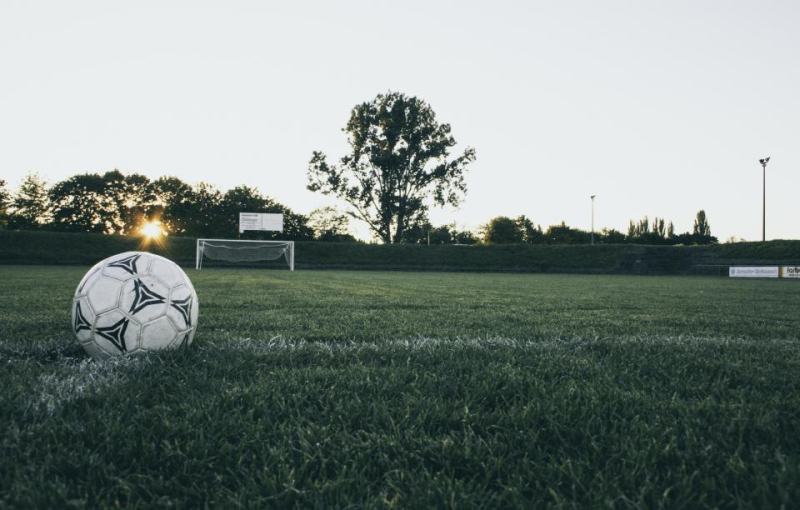 Football on a pitch at dusk