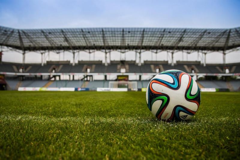 Football on the pitch of an empty stadium