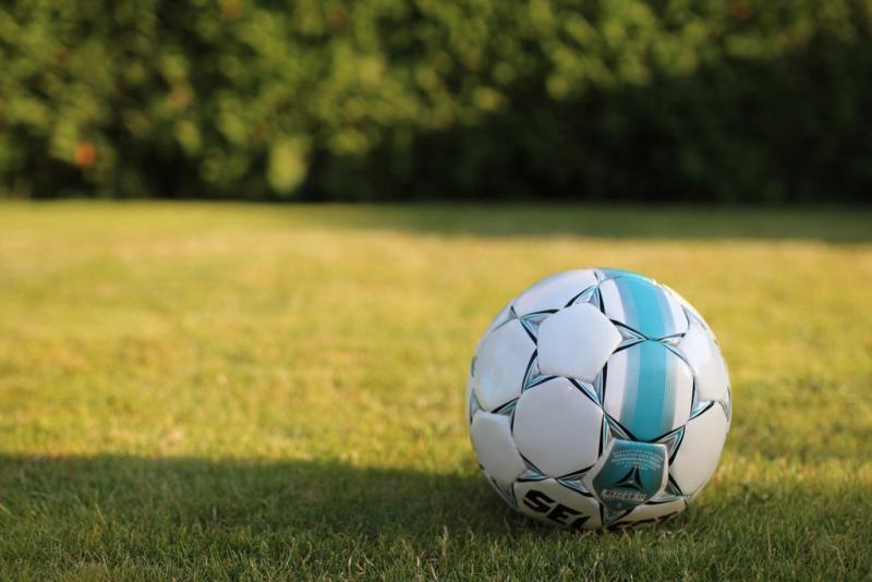 Football resting on grass