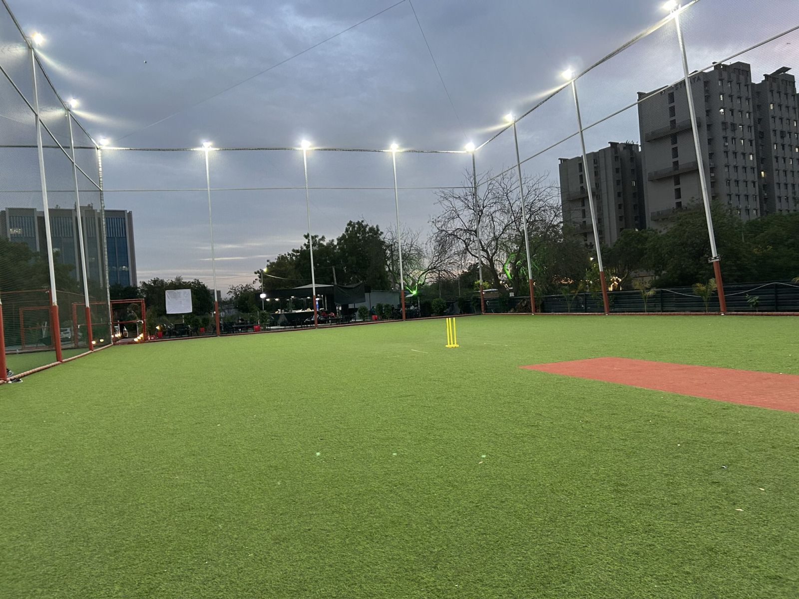 Cricket outfield under floodlights
