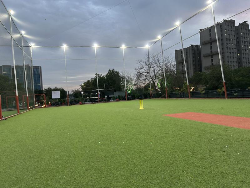 Cricket outfield under floodlights