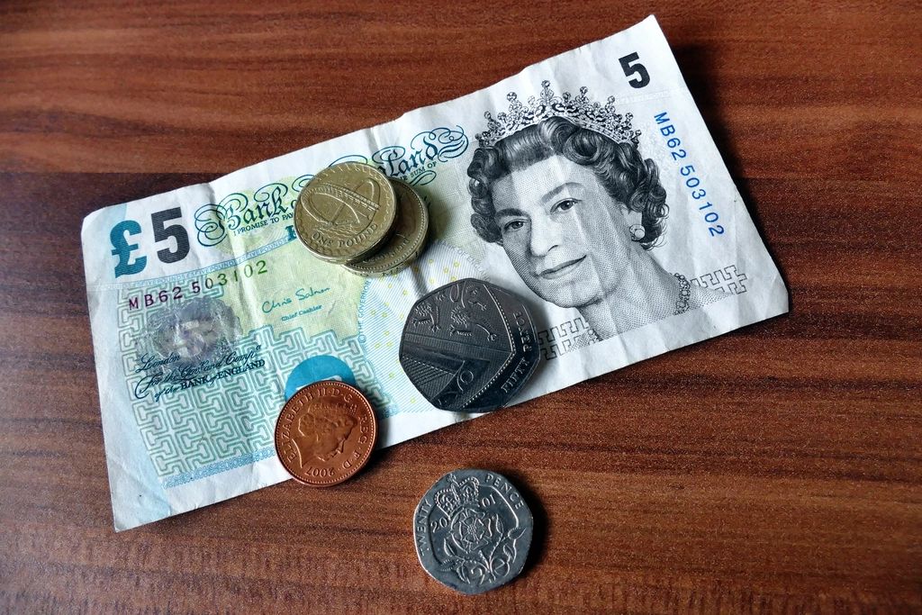 British pound coins and a five pound note